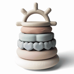 Stack of colorful silicone rings with a crown-shaped top on a white background