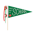 Green pennant flag with 'First Day of School' text and red apple on a white background